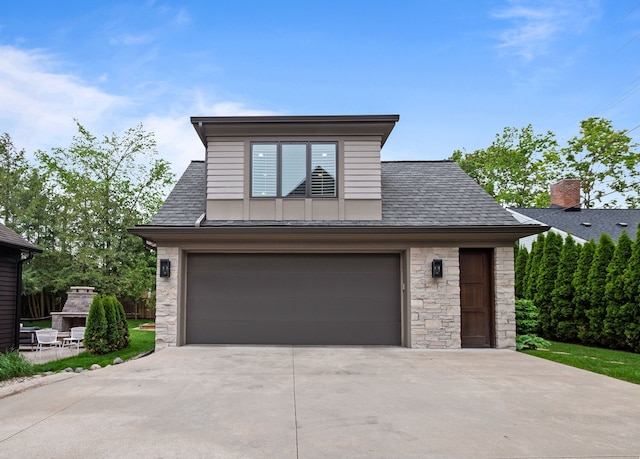 628 Watkins St, Birmingham, MI 48009 - view of front of house featuring stone siding, a garage, and driveway