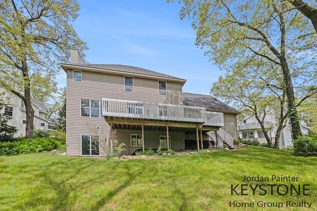 rear view of property featuring a chimney, a deck, stairs, and a yard