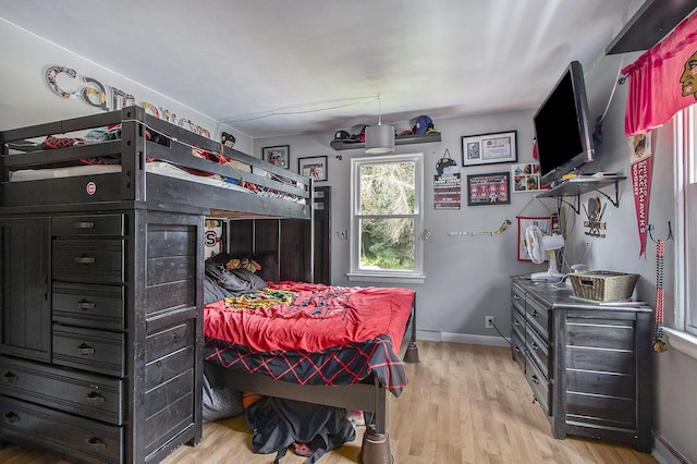 23431 Shurte St, Cassopolis, MI 49031 - bedroom featuring light wood-style floors, a baseboard heating unit, and baseboards