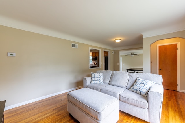 14560 Arden St, Livonia, MI 48154 - living area featuring arched walkways, wood finished floors, baseboards, and a ceiling fan