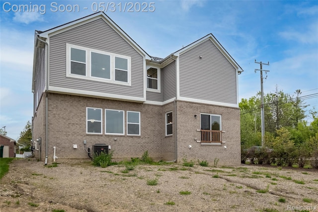 24180 Liberty Hill Dr, Farmington, MI 48336 - rear view of house featuring brick siding and central AC unit