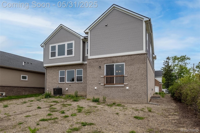 24180 Liberty Hill Dr, Farmington, MI 48336 - rear view of property featuring brick siding and central AC