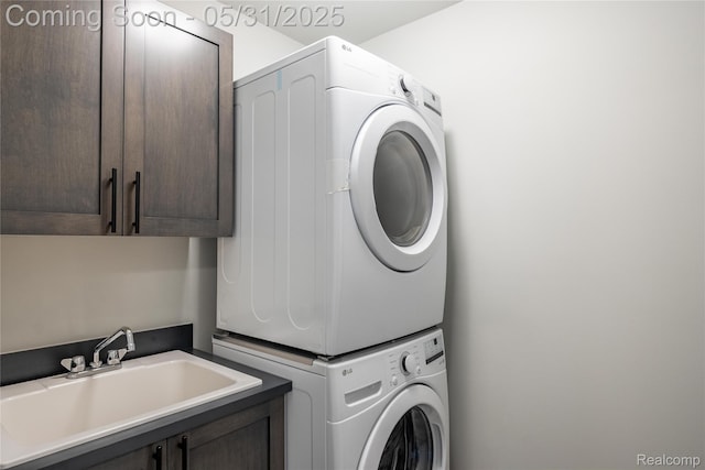 24180 Liberty Hill Dr, Farmington, MI 48336 - washroom with stacked washer and clothes dryer and cabinet space