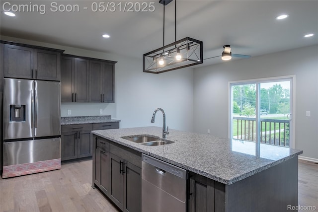 24180 Liberty Hill Dr, Farmington, MI 48336 - kitchen with appliances with stainless steel finishes, a sink, light wood finished floors, light stone counters, and recessed lighting