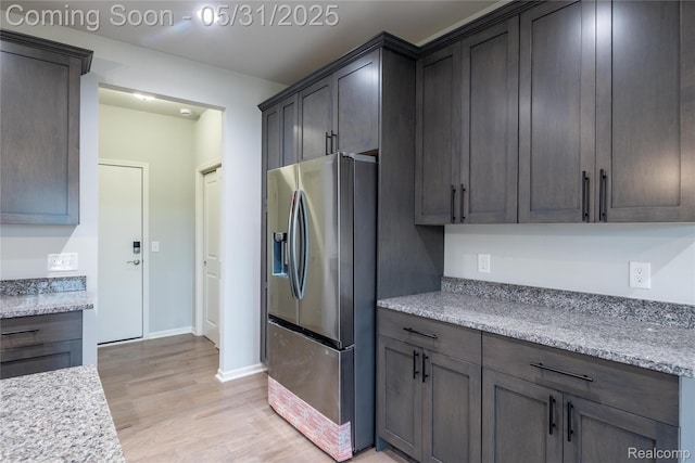 24180 Liberty Hill Dr, Farmington, MI 48336 - kitchen with stainless steel fridge, light wood finished floors, and baseboards