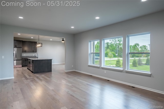 24180 Liberty Hill Dr, Farmington, MI 48336 - unfurnished living room with recessed lighting, wood finished floors, baseboards, a sink, and a ceiling fan
