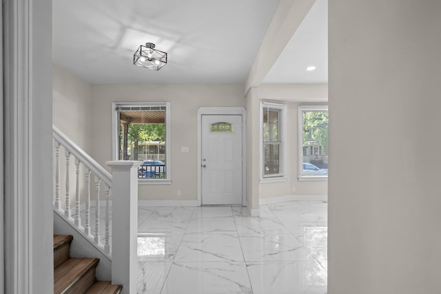 foyer with light marble finish flooring, baseboards, stairs, and recessed lighting