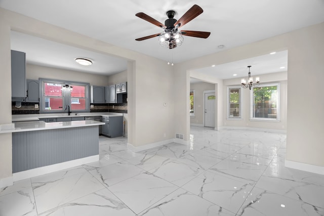 kitchen with baseboards, gray cabinets, a chandelier, a peninsula, and recessed lighting