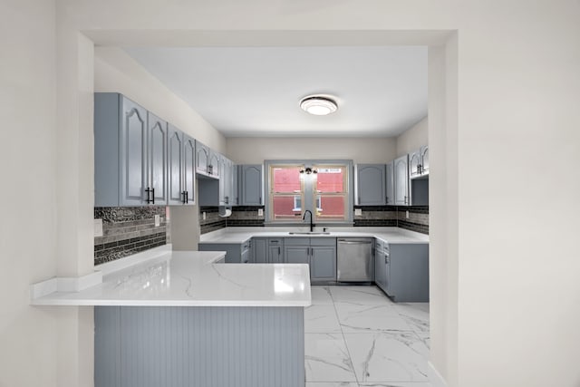 kitchen with dishwasher, a sink, a peninsula, gray cabinetry, and light marble finish flooring