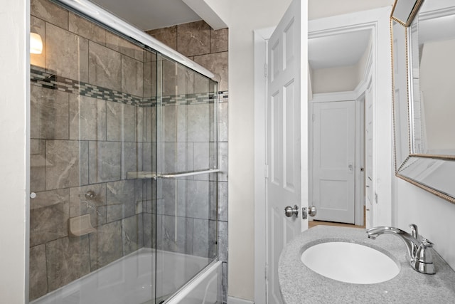 bathroom with a sink and shower / bath combination with glass door