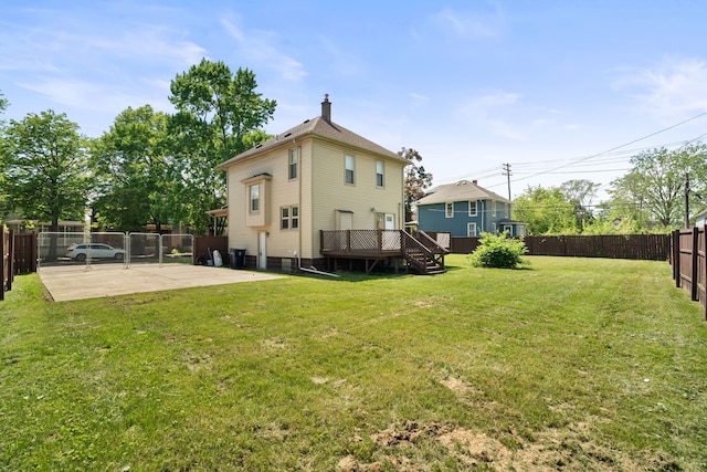 rear view of property featuring a patio, a wooden deck, a chimney, and stairway