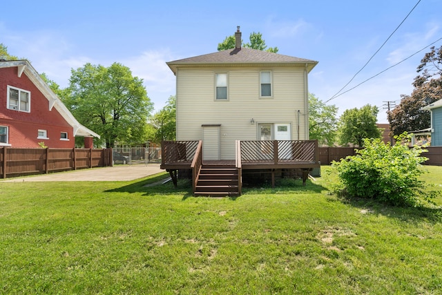 rear view of house with a wooden deck and a chimney
