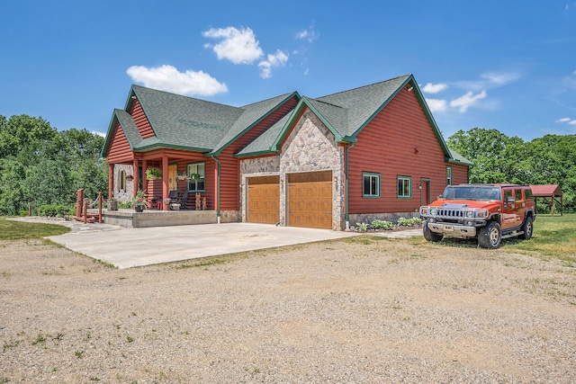 4435 Imlay City Rd, Attica, MI 48412 - view of front of house with a garage, driveway, stone siding, covered porch, and roof with shingles