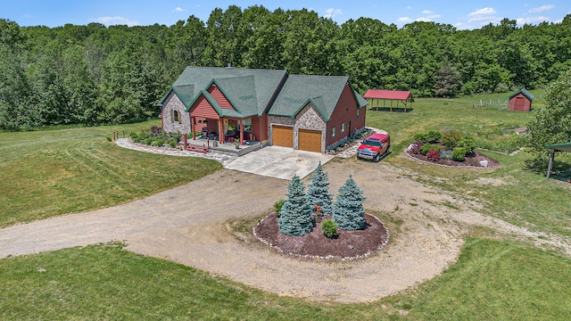 4435 Imlay City Rd, Attica, MI 48412 - view of front of property featuring dirt driveway, a front yard, stone siding, a view of trees, and an attached garage