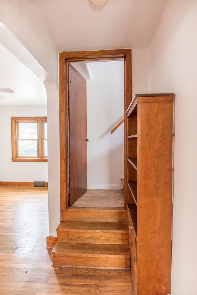 stairs featuring wood finished floors and baseboards