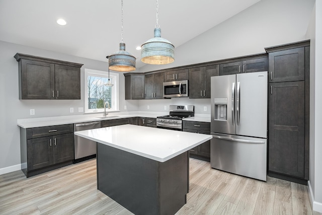 2421 Darah St, Niles, MI 49120 - kitchen featuring stainless steel appliances, a sink, light countertops, pendant lighting, and light wood-style flooring