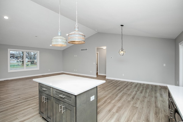 2421 Darah St, Niles, MI 49120 - kitchen with open floor plan, vaulted ceiling, light wood-style floors, light countertops, and pendant lighting