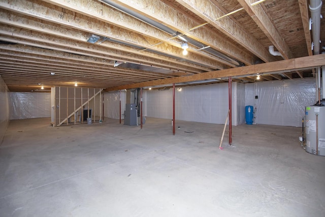 2421 Darah St, Niles, MI 49120 - unfinished basement featuring gas water heater, stairs, heating unit, and a water pressure tank