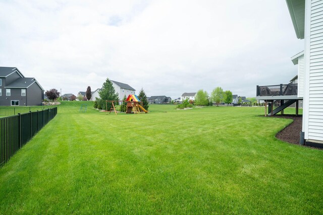 3280 Amtrak Dr SW, Byron Center, MI 49315 - view of yard with a playground, a residential view, stairway, and a deck