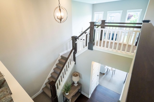 3280 Amtrak Dr SW, Byron Center, MI 49315 - staircase featuring a chandelier and wood finished floors
