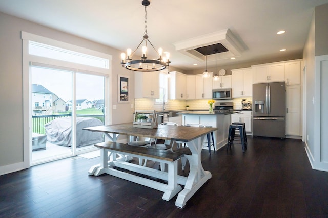 3280 Amtrak Dr SW, Byron Center, MI 49315 - dining space featuring a chandelier, dark wood-style floors, and recessed lighting
