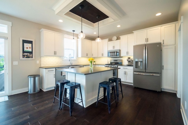 3280 Amtrak Dr SW, Byron Center, MI 49315 - kitchen featuring stainless steel appliances, a breakfast bar area, dark wood-type flooring, a sink, and recessed lighting