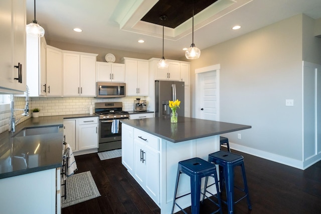 3280 Amtrak Dr SW, Byron Center, MI 49315 - kitchen with appliances with stainless steel finishes, dark countertops, recessed lighting, dark wood-style floors, and a sink