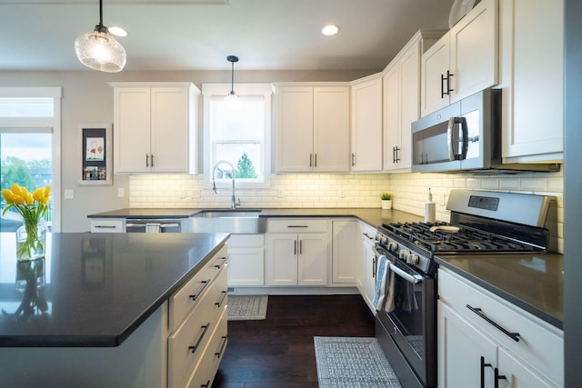 3280 Amtrak Dr SW, Byron Center, MI 49315 - kitchen with appliances with stainless steel finishes, a sink, dark countertops, healthy amount of natural light, and recessed lighting