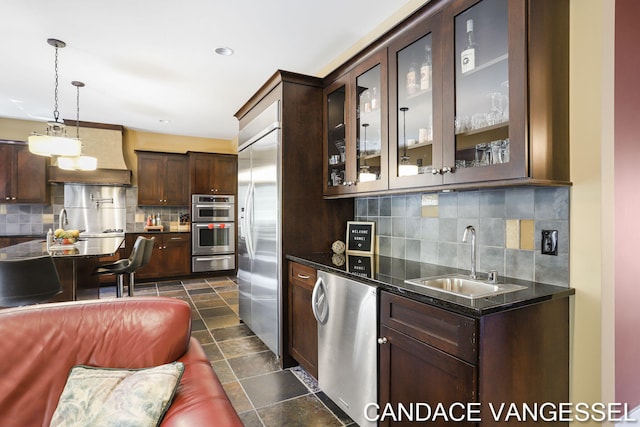 2429 Shears Crossing Ct NE, Grand Rapids, MI 49525 - kitchen with a sink, stainless steel appliances, a warming drawer, premium range hood, and dark brown cabinets
