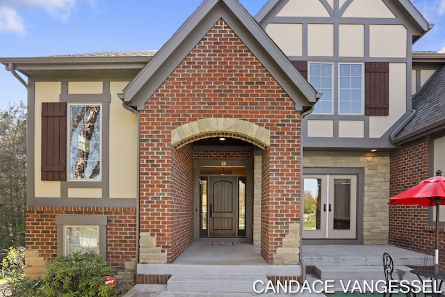 2429 Shears Crossing Ct NE, Grand Rapids, MI 49525 - property entrance with brick siding, french doors, stone siding, and stucco siding