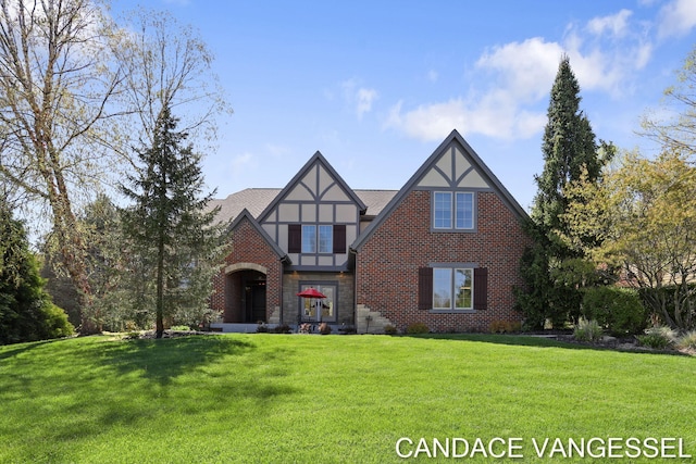 2429 Shears Crossing Ct NE, Grand Rapids, MI 49525 - tudor-style house with a front lawn, brick siding, and stucco siding