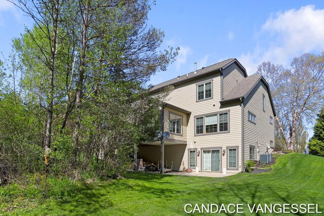 2429 Shears Crossing Ct NE, Grand Rapids, MI 49525 - back of house with central air condition unit, a yard, and a patio area