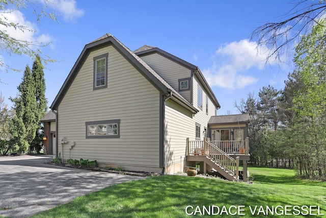 2429 Shears Crossing Ct NE, Grand Rapids, MI 49525 - view of side of home with stairs, a lawn, and a wooden deck