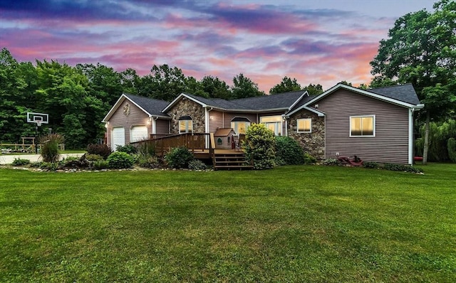 5856 Peck Rd, Brown City, MI 48416 - ranch-style house with stone siding, a deck, a front yard, and a garage