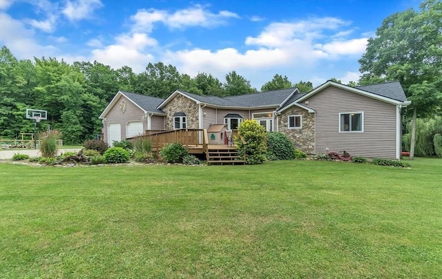 5856 Peck Rd, Brown City, MI 48416 - view of front facade with stone siding, a front lawn, a deck, and a garage