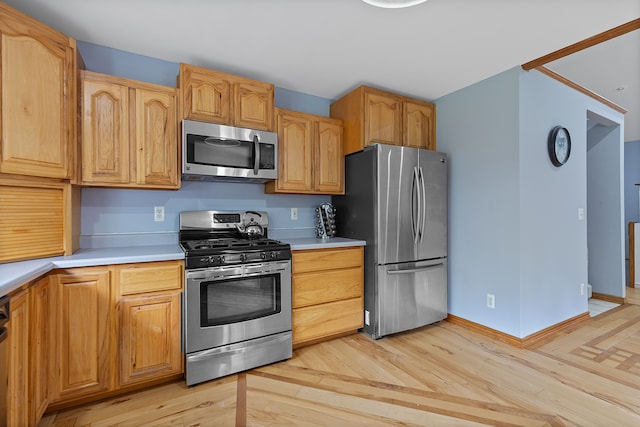 5856 Peck Rd, Brown City, MI 48416 - kitchen featuring stainless steel appliances, light countertops, light wood-style flooring, and baseboards