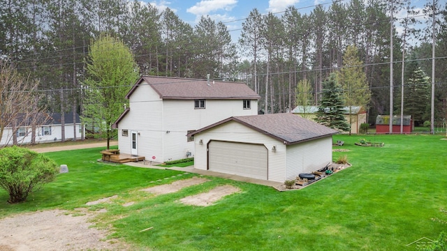 217 Maple Rd, Roscommon, MI 48653 - view of side of home featuring a garage, an outbuilding, a lawn, and a shingled roof