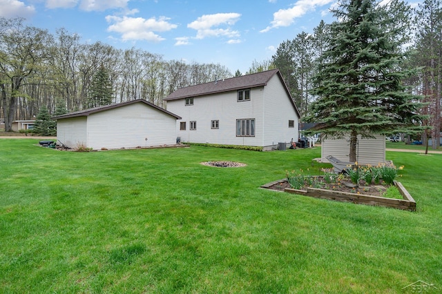217 Maple Rd, Roscommon, MI 48653 - back of house with a yard, an outbuilding, cooling unit, and a garden