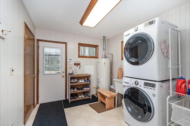 217 Maple Rd, Roscommon, MI 48653 - laundry room featuring gas water heater, estacked washer and dryer, and light floors