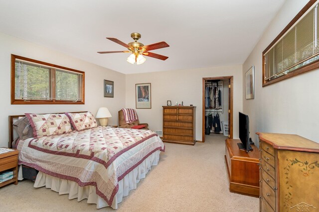 217 Maple Rd, Roscommon, MI 48653 - bedroom with light carpet, a walk in closet, a closet, and ceiling fan