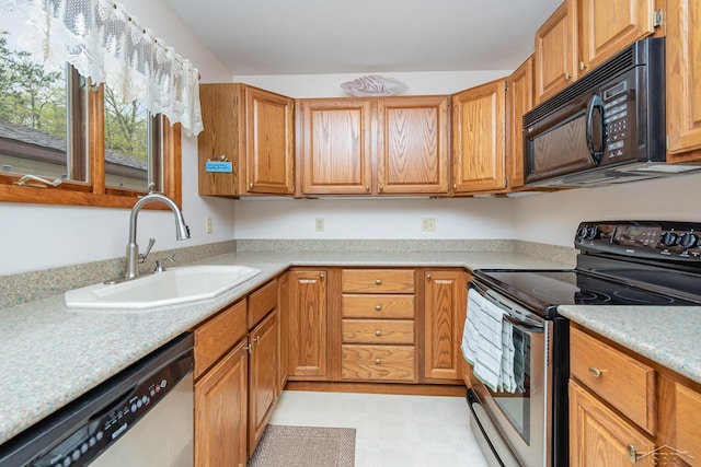 217 Maple Rd, Roscommon, MI 48653 - kitchen featuring appliances with stainless steel finishes, light flooring, light countertops, and brown cabinetry
