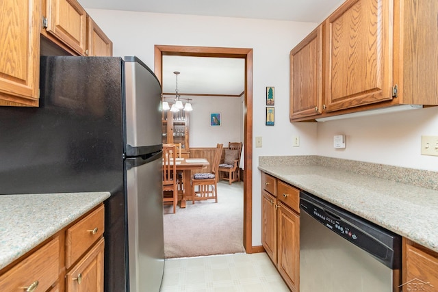 217 Maple Rd, Roscommon, MI 48653 - kitchen featuring stainless steel appliances, light countertops, light colored carpet, brown cabinets, and light flooring
