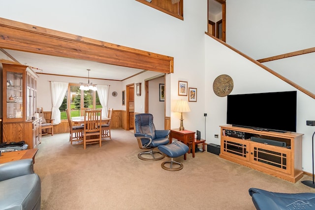 217 Maple Rd, Roscommon, MI 48653 - carpeted living area featuring a chandelier, a wainscoted wall, and ornamental molding