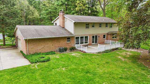 1558 Sylvan Glen Rd, Okemos, MI 48864 - rear view of property featuring brick siding, cooling unit, a yard, a wooden deck, and roof with shingles