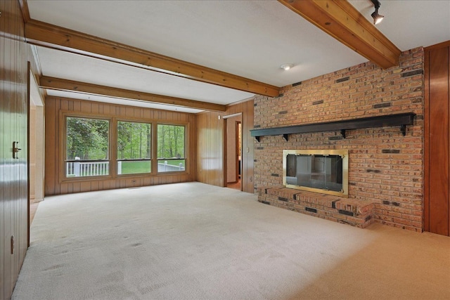 1558 Sylvan Glen Rd, Okemos, MI 48864 - unfurnished living room with carpet floors, beamed ceiling, a brick fireplace, and wood walls