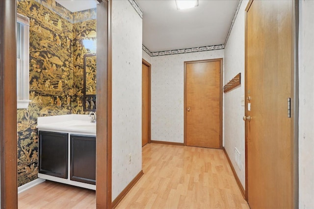 1558 Sylvan Glen Rd, Okemos, MI 48864 - hall featuring wallpapered walls, light wood-type flooring, and baseboards