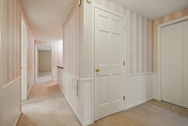 1558 Sylvan Glen Rd, Okemos, MI 48864 - hallway featuring wallpapered walls, light carpet, wainscoting, and baseboards