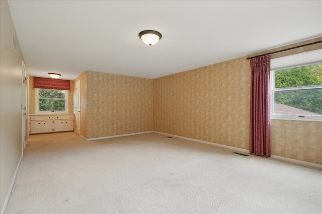 1558 Sylvan Glen Rd, Okemos, MI 48864 - spare room with light carpet, baseboards, and wallpapered walls