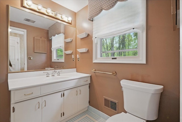 1558 Sylvan Glen Rd, Okemos, MI 48864 - bathroom featuring plenty of natural light, tile patterned flooring, toilet, and vanity