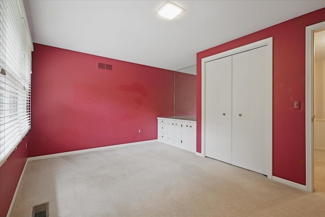 1558 Sylvan Glen Rd, Okemos, MI 48864 - unfurnished bedroom featuring carpet flooring, baseboards, and a closet